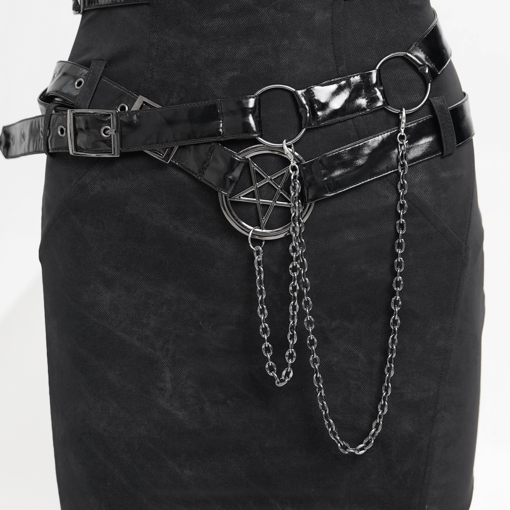 Detailed view of black halter dress featuring chains, buckles, and a pentagram accessory for a punk rock look.