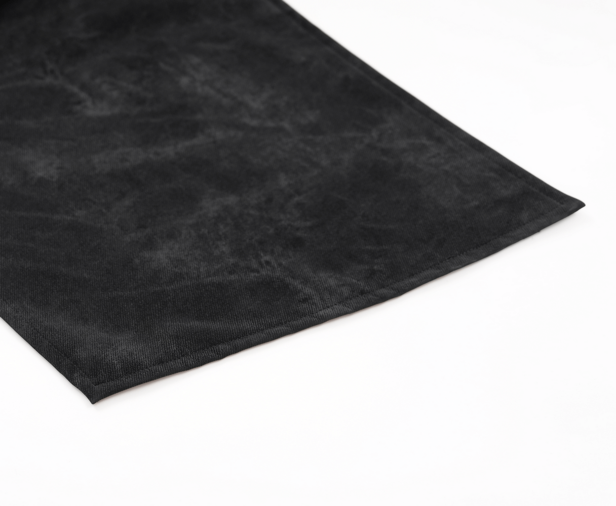 close-up of a soft black suede fabric with a smooth finish, showcasing texture and elegance. Perfect for fashion or home decor.