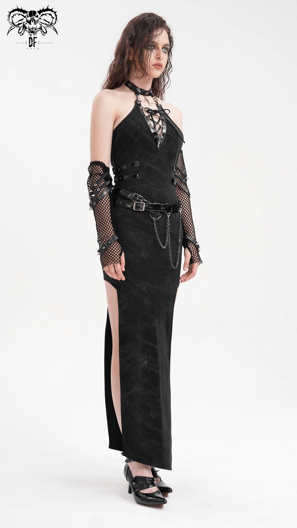 Bold black halter dress with chains and buckles, high slit, and edgy lace-up design for alternative fashion lovers.