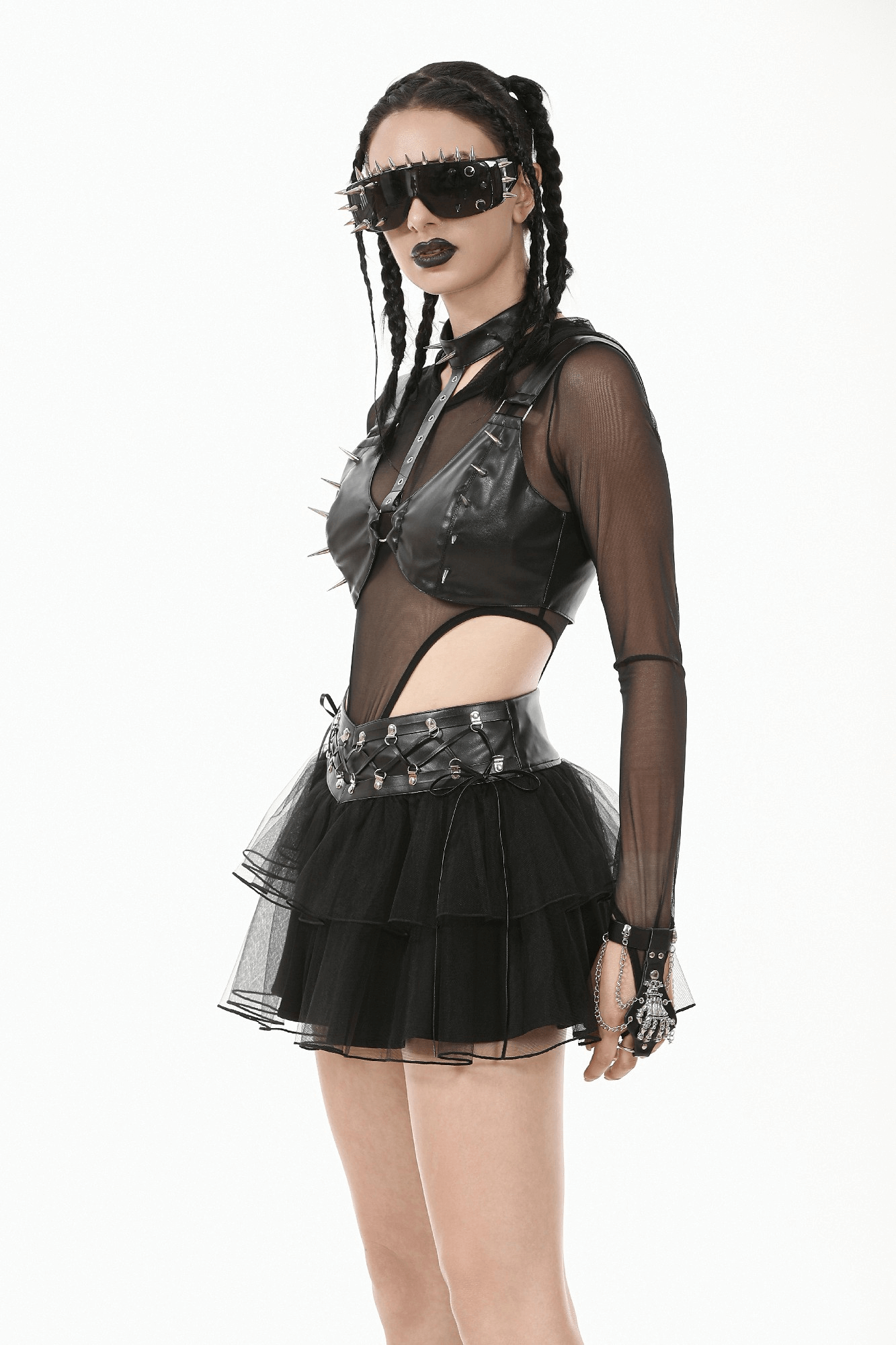 Bold gothic punk outfit featuring a spiked faux leather top, tulle skirt, and edgy accessories for alternative fashion.