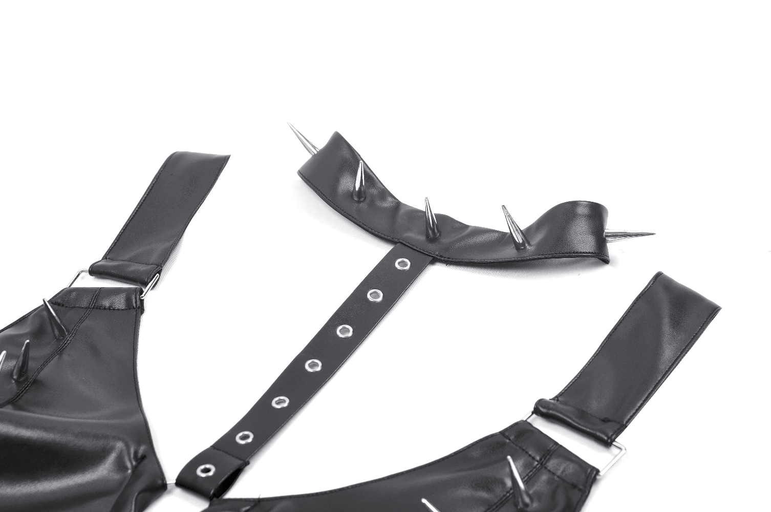 Close-up of a bold faux leather bra top with silver spikes and detachable neck harness strap for punk fashion.