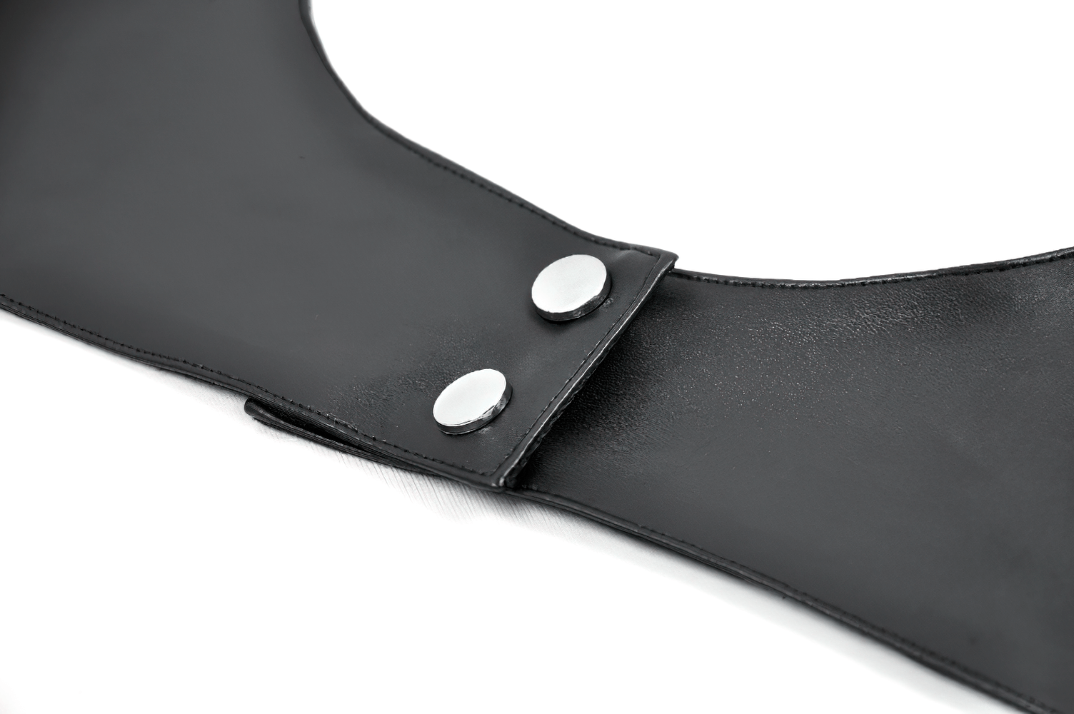 Close-up of a black faux leather collar with silver snap buttons, ideal for a punk or gothic outfit.