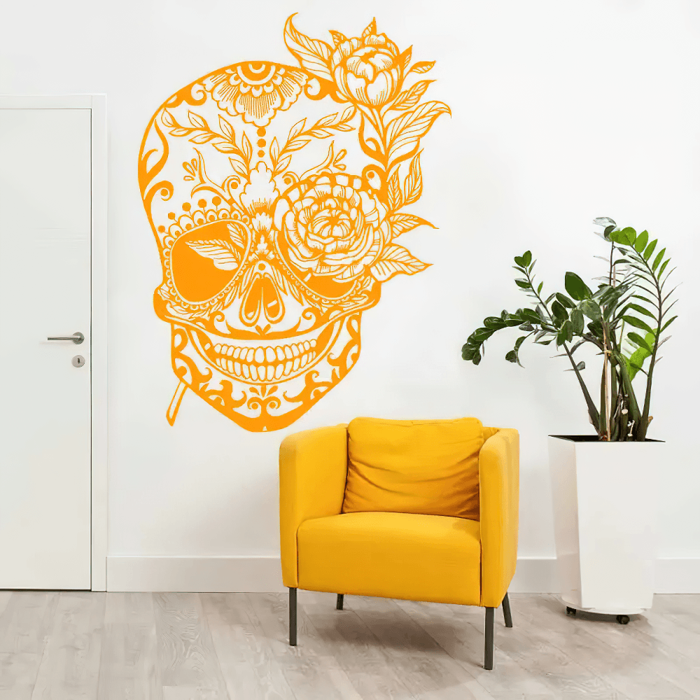 Bold Floral Sugar Skull Day of the Dead Wall Decal in vibrant orange on a white wall, placed near a stylish yellow armchair.