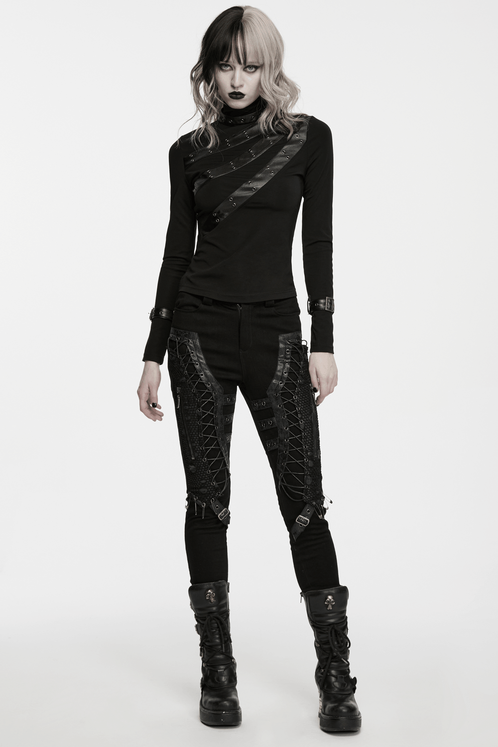 Model showcasing Bold Gothic Lace-Up Skinny Jeans with Buckle Details, paired with a stylish black top and edgy boots.
