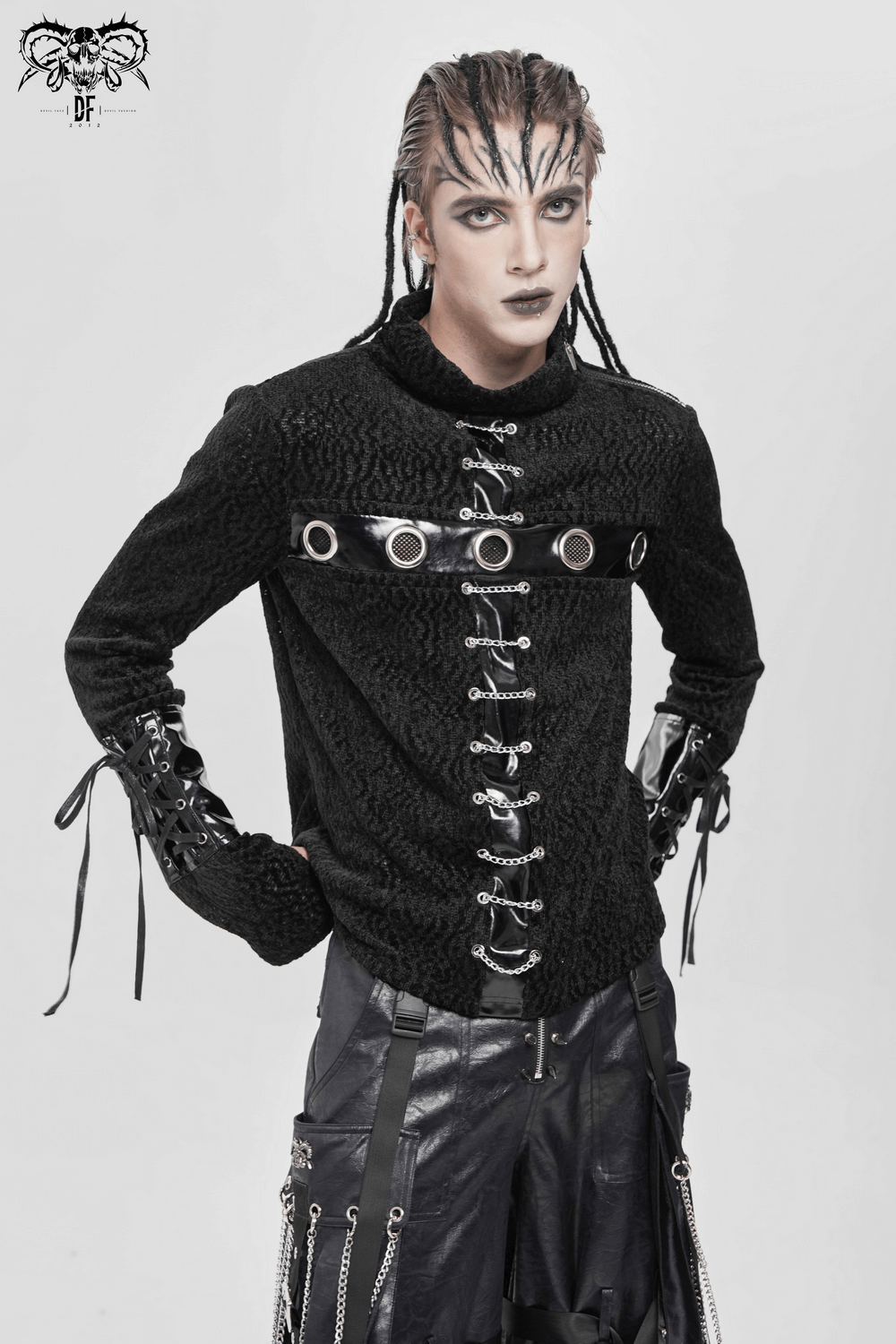 Bold Knit Turtleneck with Faux Leather Straps and Chains worn by model, featuring eyelet and chain design.