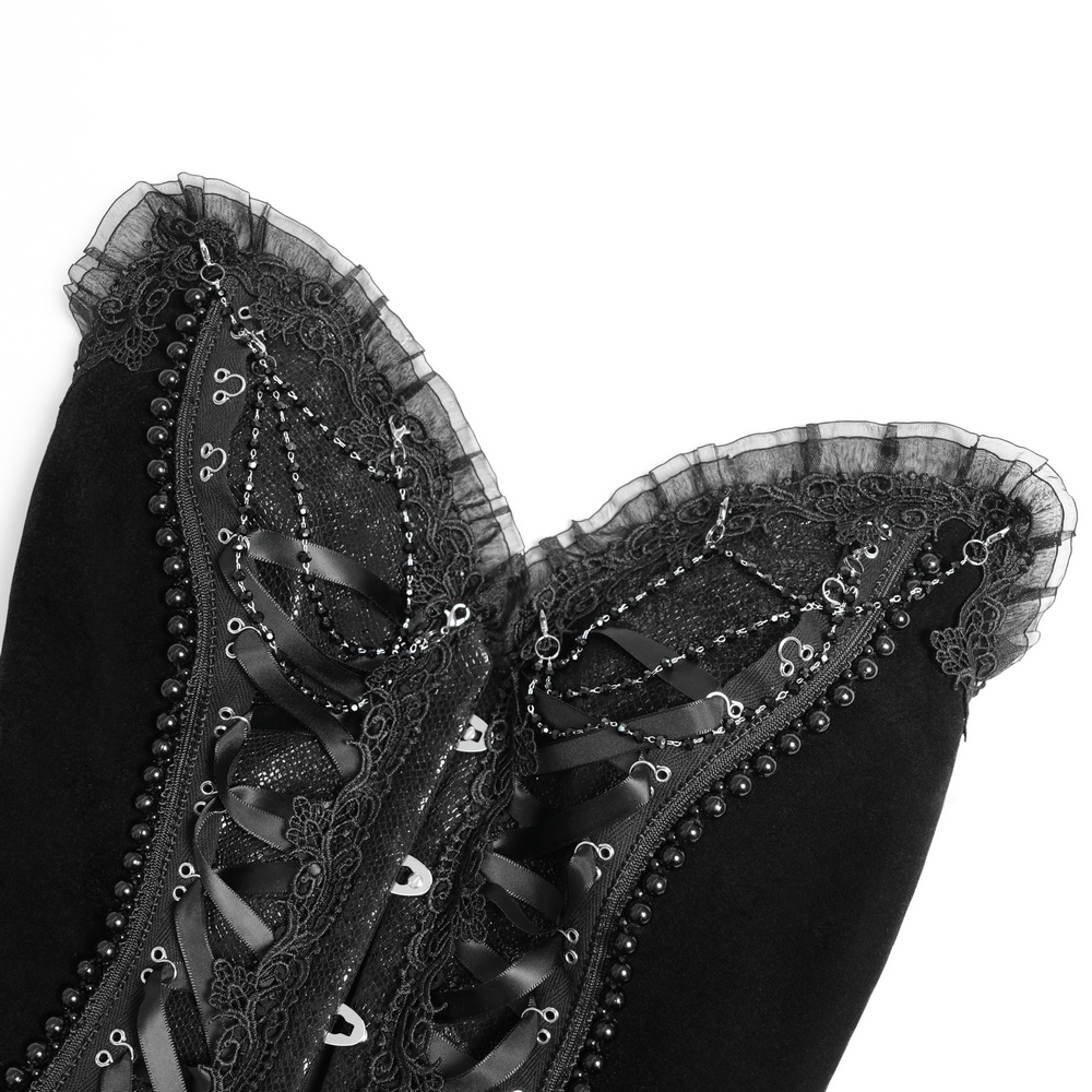 Close-up of a gothic lace-up corset with ruffle trim, black satin, and delicate lace detailing.