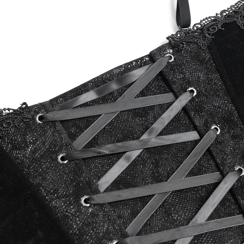 Close-up of bold black lace-up corset with satin ribbons and delicate ruffle trim, showcasing intricate detail.