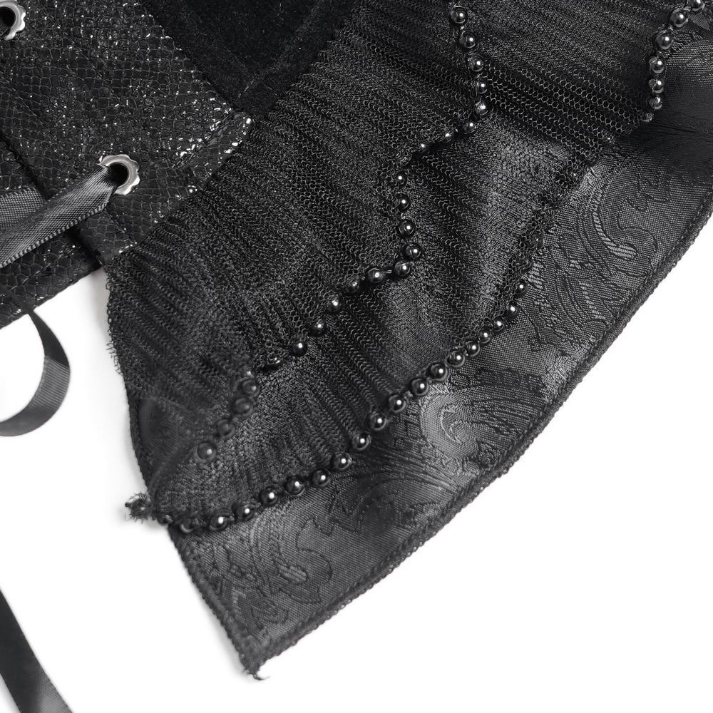 Close-up of a bold black lace corset with ruffled hem, satin ribbons, and decorative bead detailing.