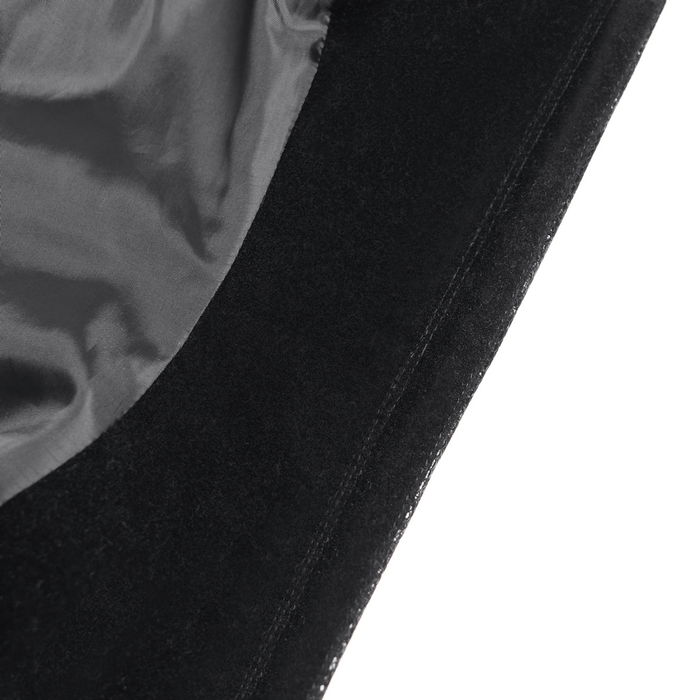 Close-up of a bold black satin corset hem showcasing delicate lace and ruffle trim details.