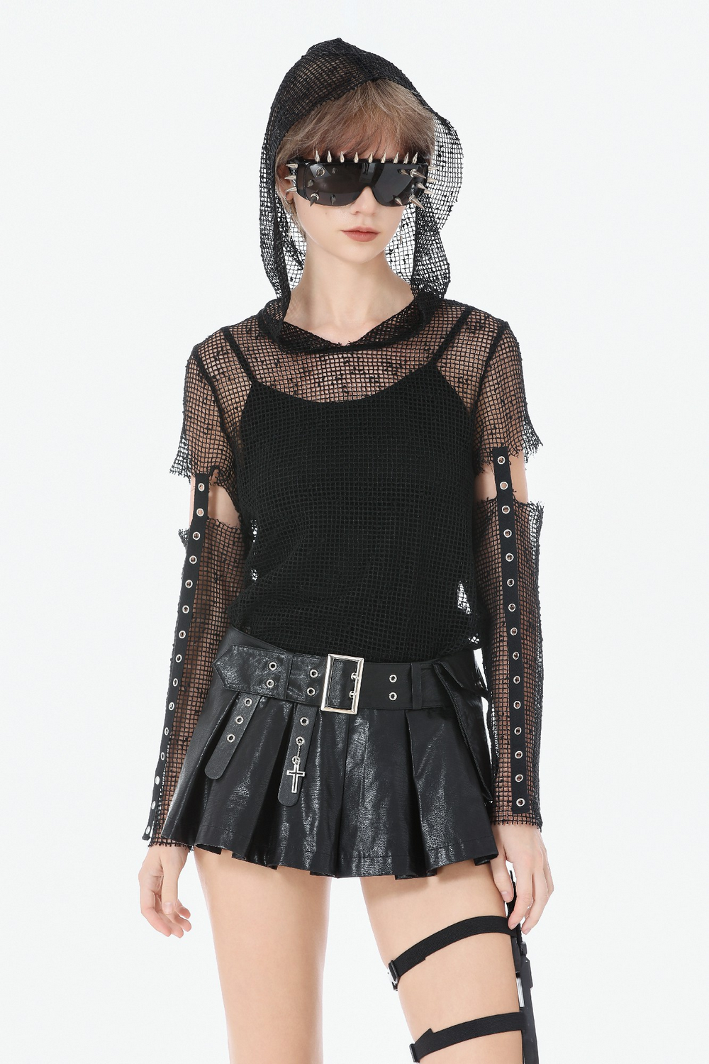 Bold Pleated Skirt Shorts with Belt and Cross Charm styled with a mesh top and sunglasses for a punk look.