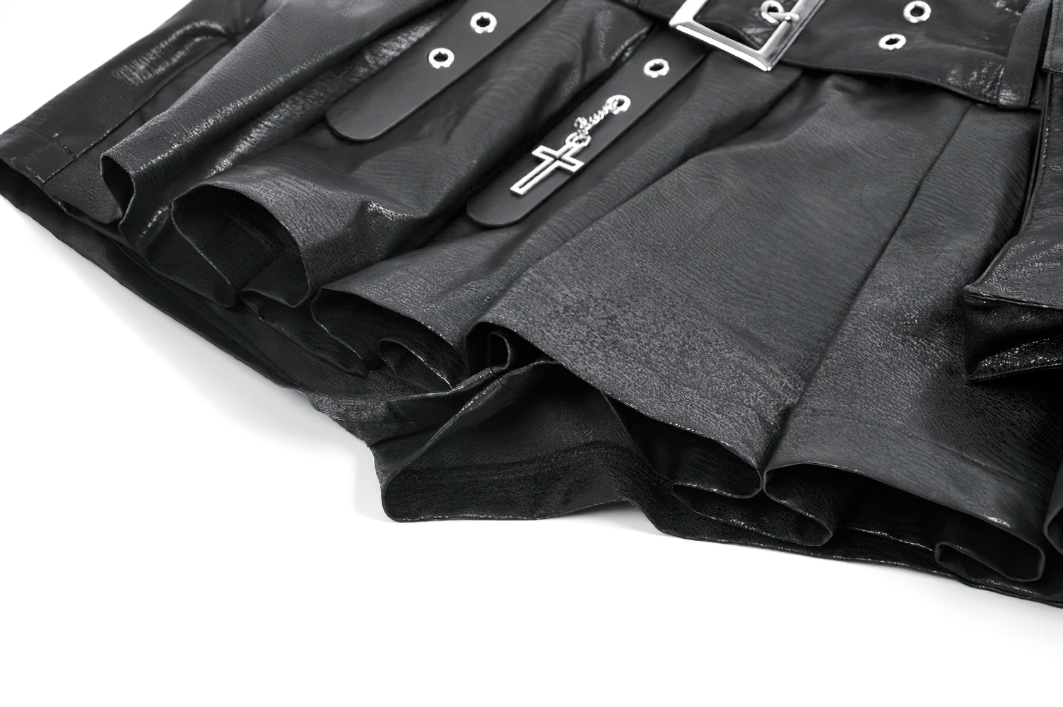 Bold Pleated Skirt Shorts with Belt and Cross Charm showcasing black faux leather and metal grommets.