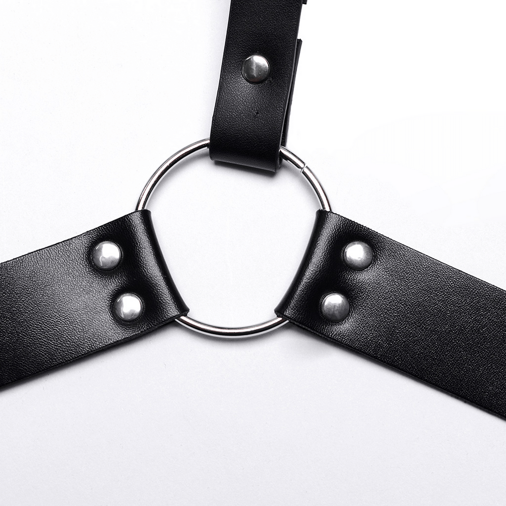 Close-up of a black PU leather body harness with metal ring and studs for an edgy punk fashion statement.