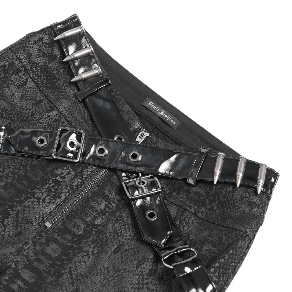 Close-up of bold skinny pants featuring straps, buckles, and snakeskin pattern for edgy streetwear style.