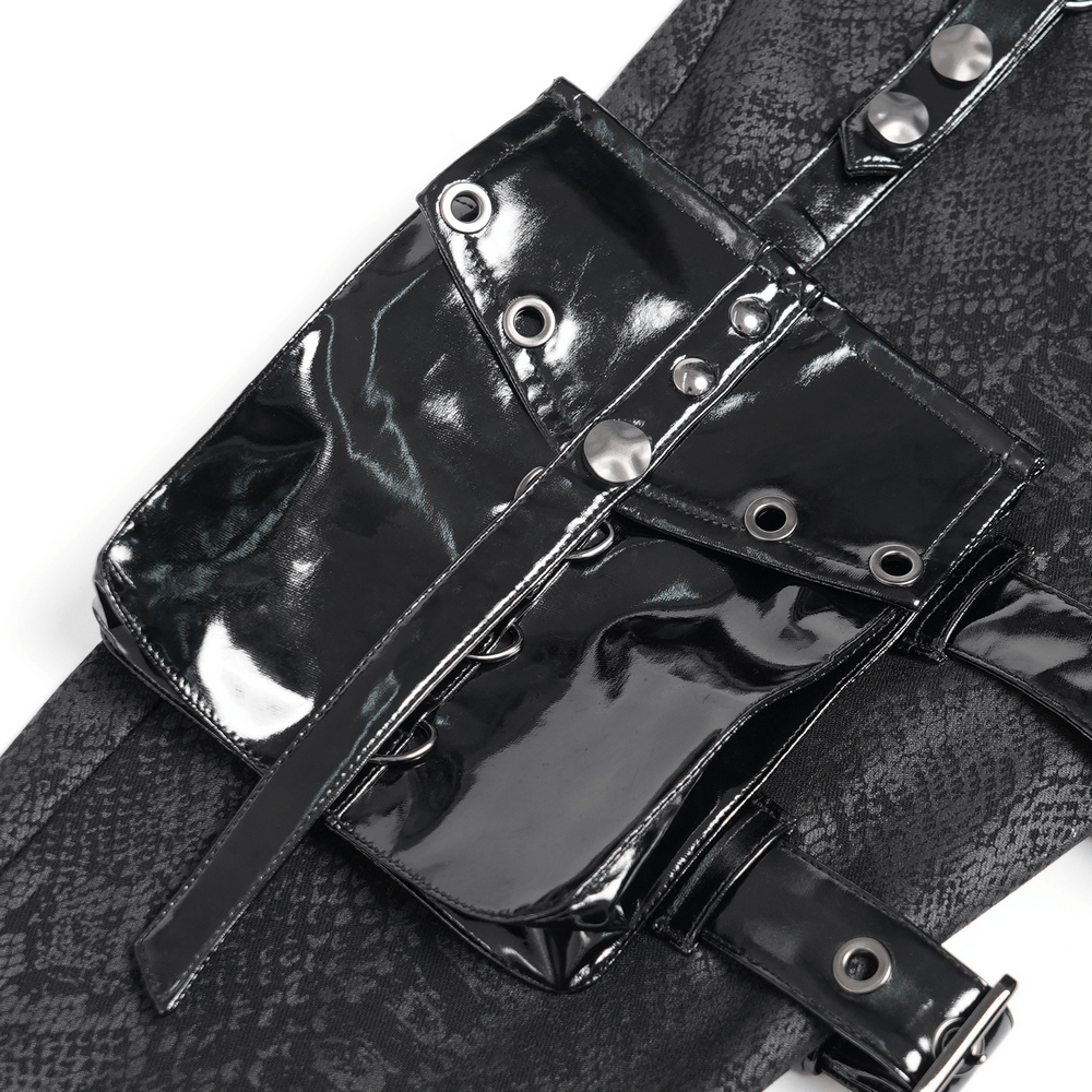 Close-up of shiny black detachable side pouch with buckles and snaps on punk skinny pants.
