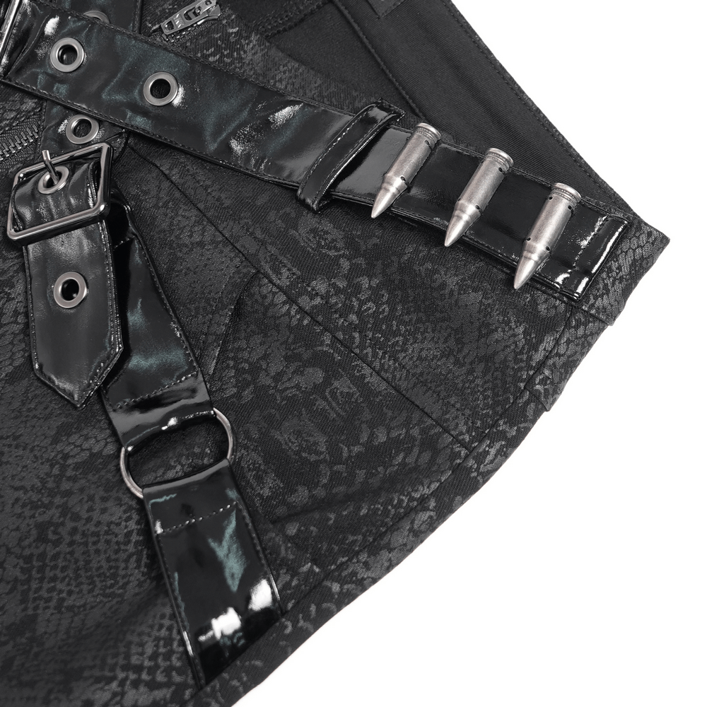 Close-up of bold skinny pants featuring black faux leather straps and spikes, showcasing a snakeskin pattern.
