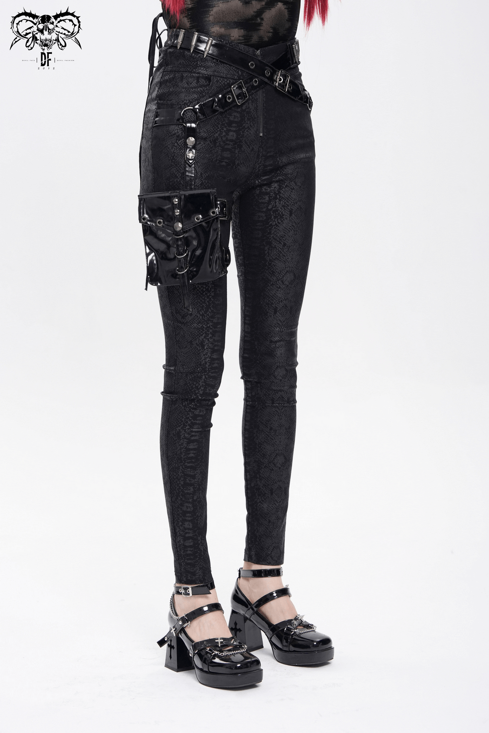 Bold black skinny pants with buckles, faux leather pouch, and snakeskin pattern for a punk streetwear vibe.