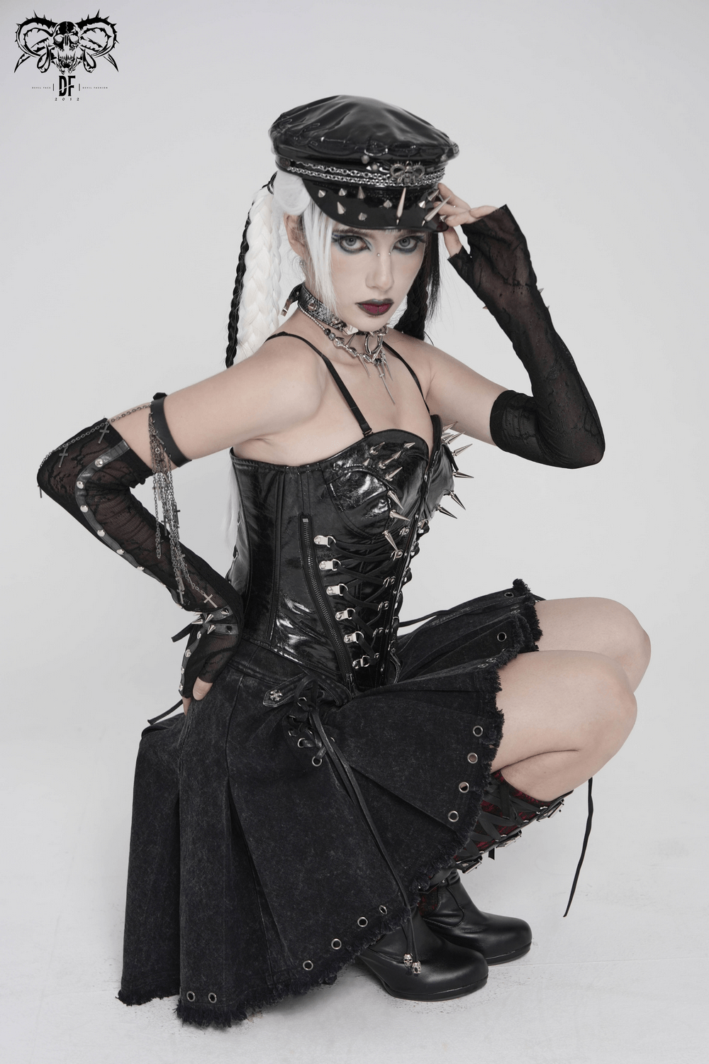 Bold Spike Corset Top with Lace Up Punk Hardware worn by a model in a dramatic pose, showcasing gothic fashion and punk style.