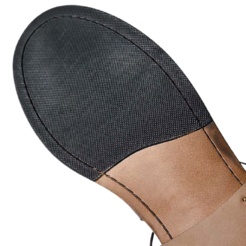 Close-up of the durable sole of men's genuine leather boots, showcasing vintage design and quality craftsmanship.