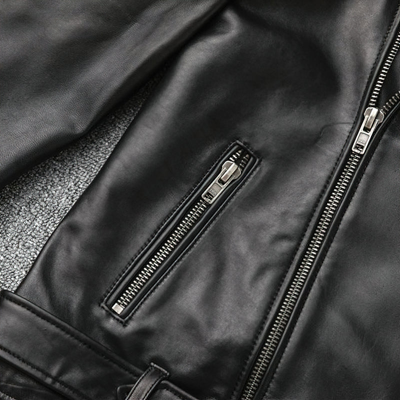 Close-up of a black leather biker jacket showing a stylish zippered pocket and smooth texture.