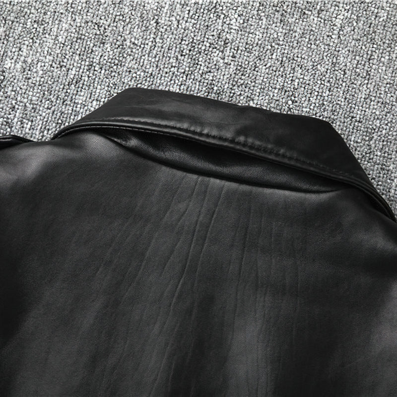 Close-up of the collar and back detail of a black genuine leather biker jacket.