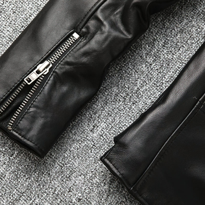 Close-up of a sleek black leather biker jacket sleeve featuring a stylish zipper.