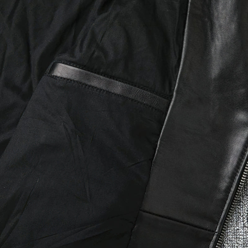 Interior view of a classic men's leather biker jacket showcasing the black lining and removable belt feature.