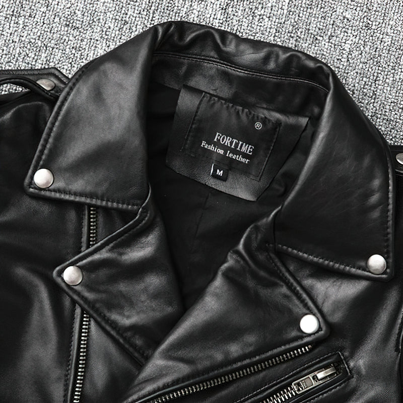 Close-up of a black genuine leather biker jacket collar with stylish metal buttons and brand label inside.