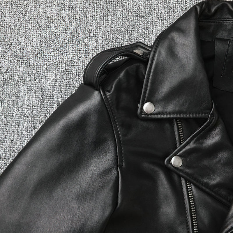 Close-up of a sleek black genuine leather biker jacket showcasing stylish metal buttons and tailored collar.