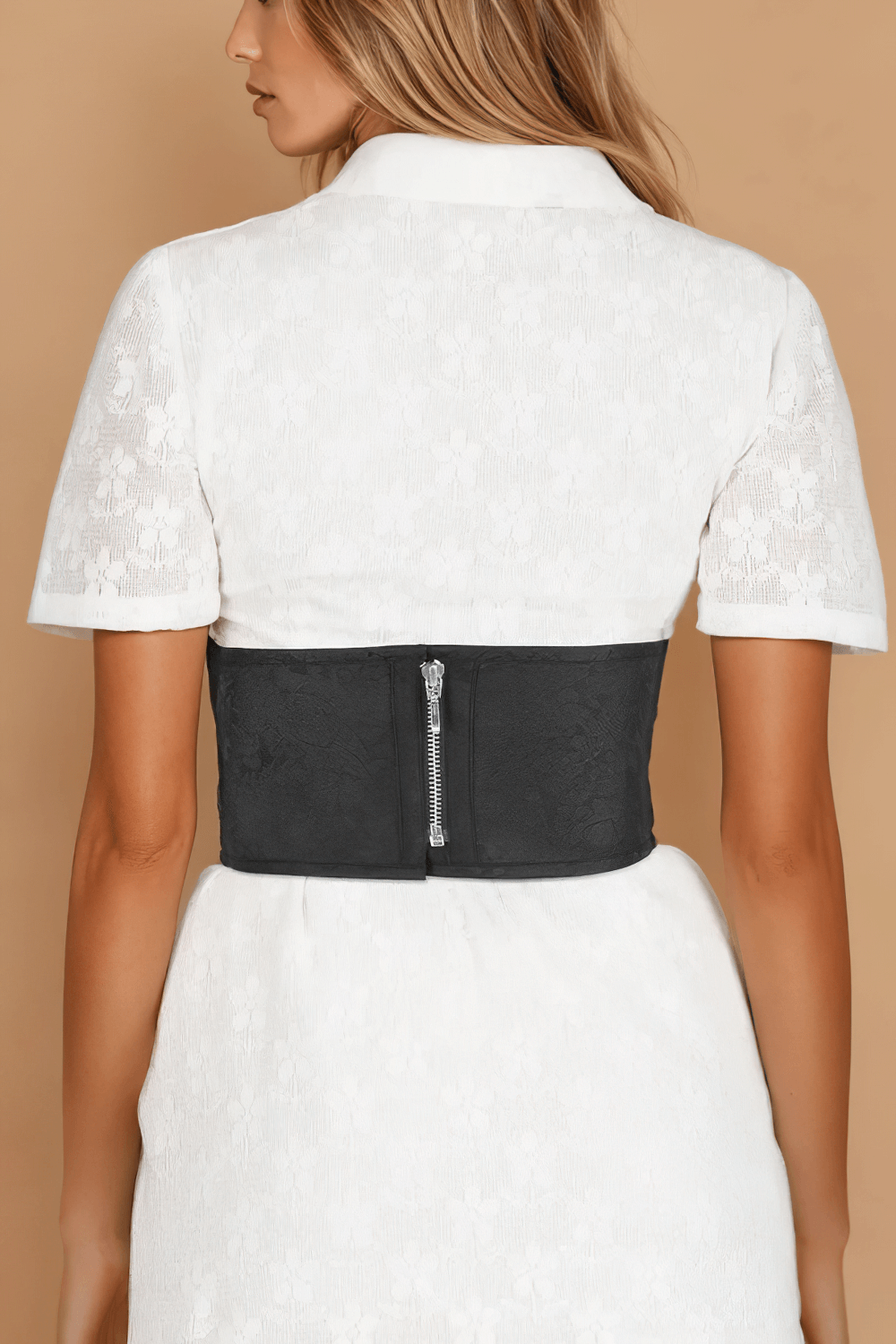 Elegant black brocade corset belt with back zipper worn over a white dress.