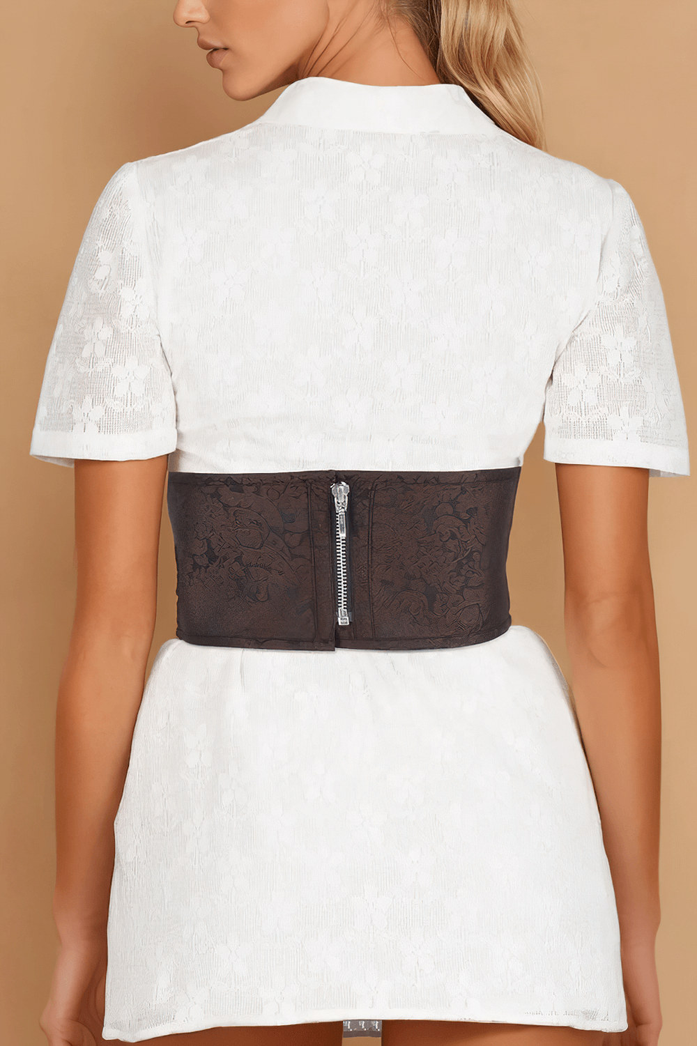 Elegant brocade corset belt in rich maroon, featuring zipper and lace-up design, worn over a white dress.