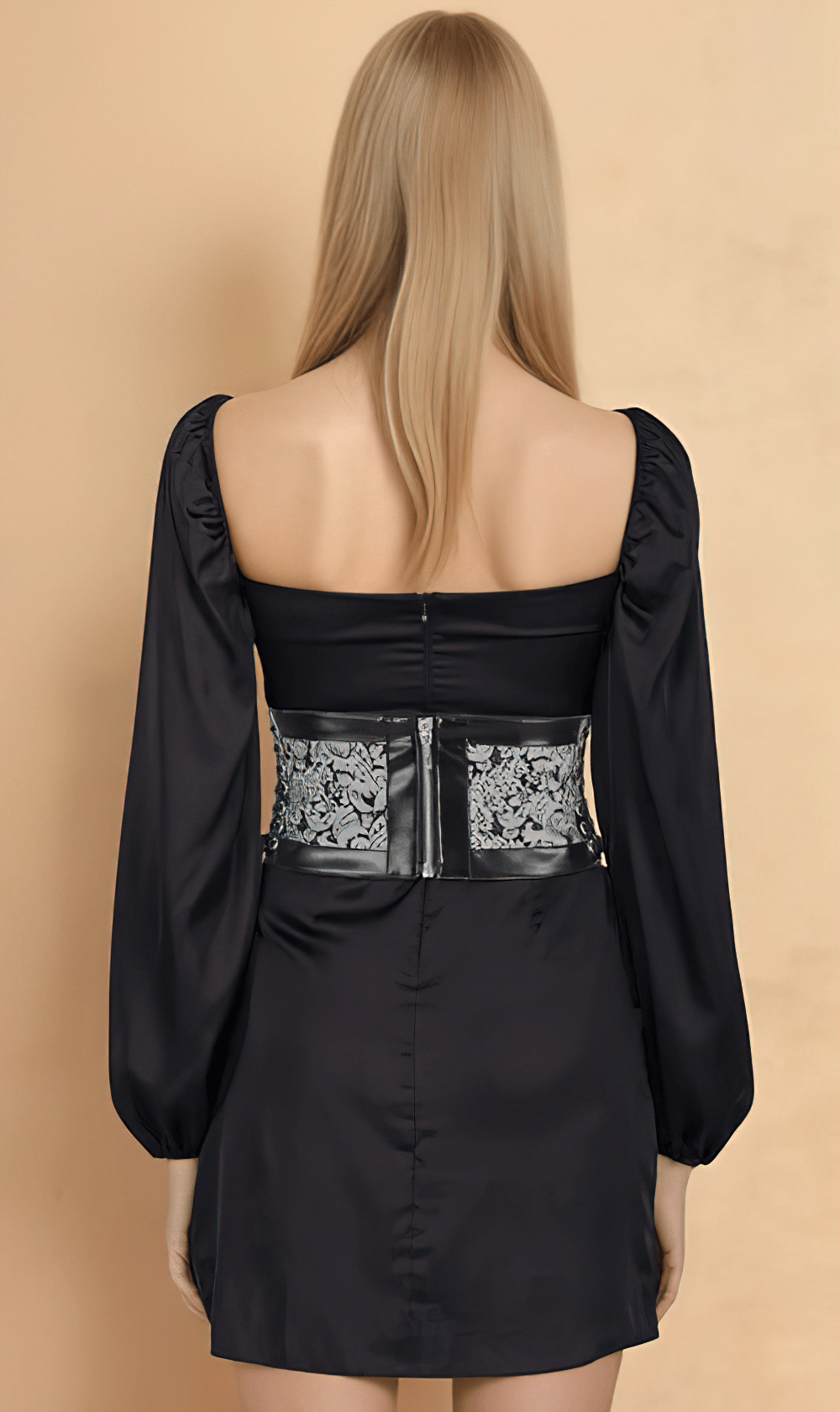 Back view of a model wearing a black dress with a brocade corset belt, showcasing elegant gothic style.