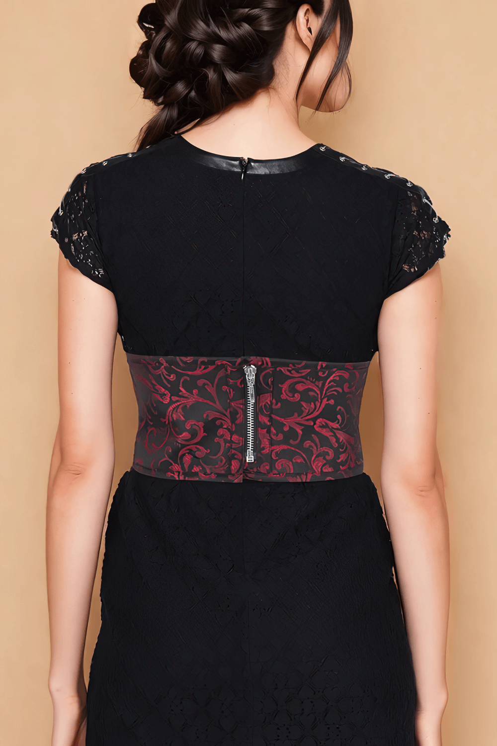 Elegant woman showcasing brocade corset belt with lace-up front and zipper detail, enhancing her waistline.