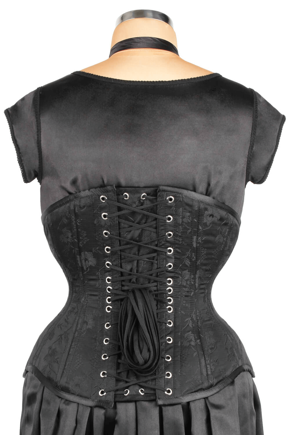 Back view of a black brocade underbust corset showcasing tight lacing and a sleek silhouette for waist training.