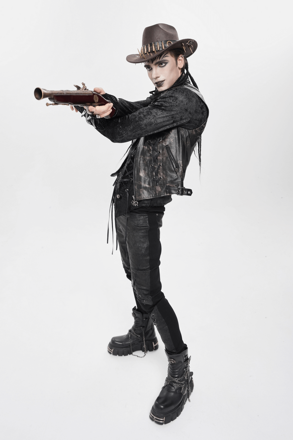 Brown Gothic Cowboy Hat with Metal Bullets and Spikes worn by a model in a rugged steampunk look holding a rifle.