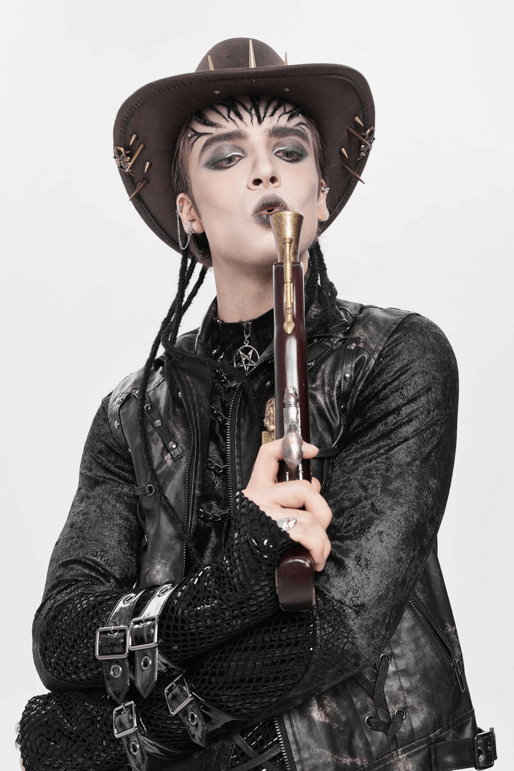 Brown Gothic Cowboy Hat with Metal Bullets and Spikes worn by a model holding a vintage pistol in a steampunk outfit.