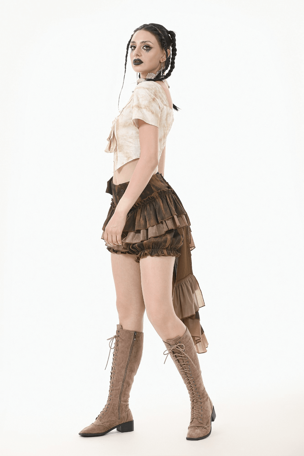 Model wearing brown steampunk ruffled skirt shorts with a dramatic back hem and vintage style, paired with lace-up boots.