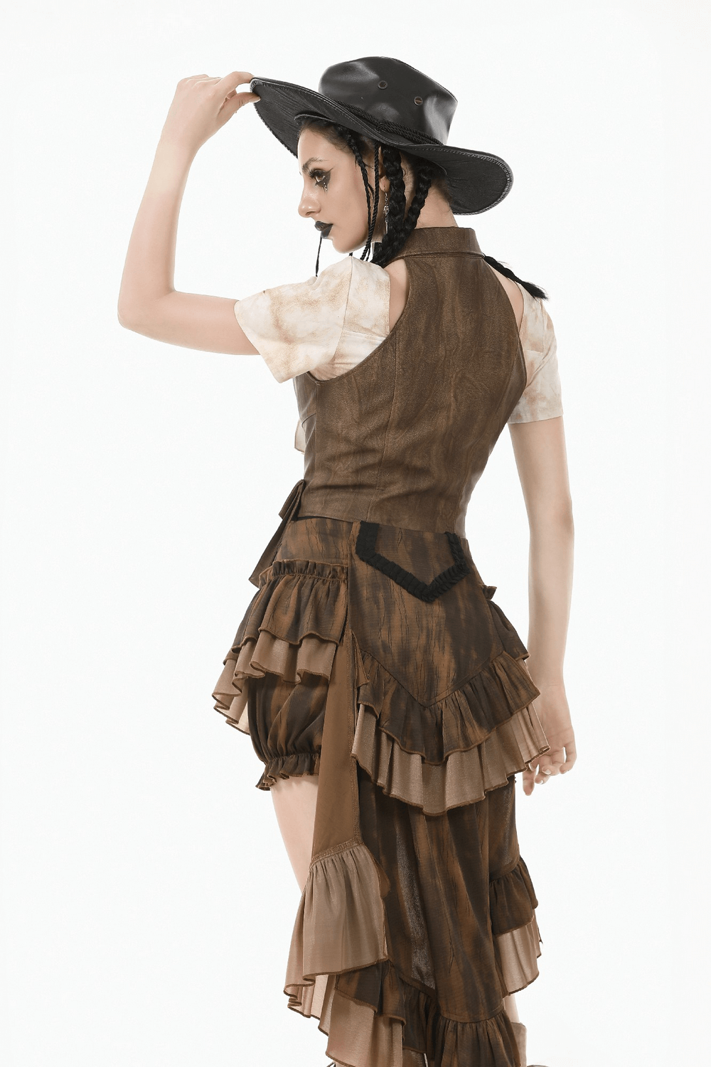 Back view of a model in a brown steampunk ruffled skirt shorts with cascading train and vintage style hat.