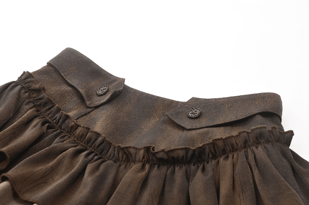 Close-up of brown steampunk ruffled skirt shorts with vintage buttons and elasticized waist for a secure fit.