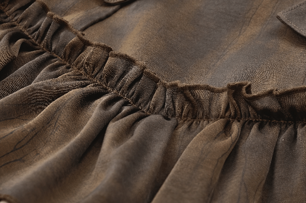 Close-up of the ruffled texture on a brown steampunk skirt shorts with a vintage worn effect.