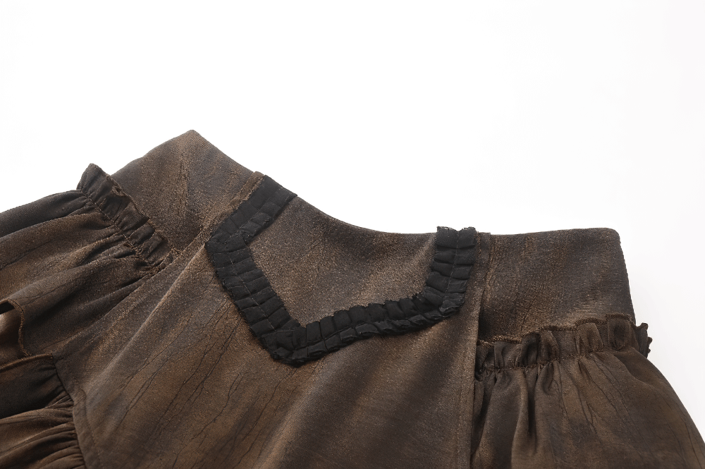 Close-up of brown steampunk skirt shorts, featuring a vintage look with layered ruffles and black trim on the neckline.