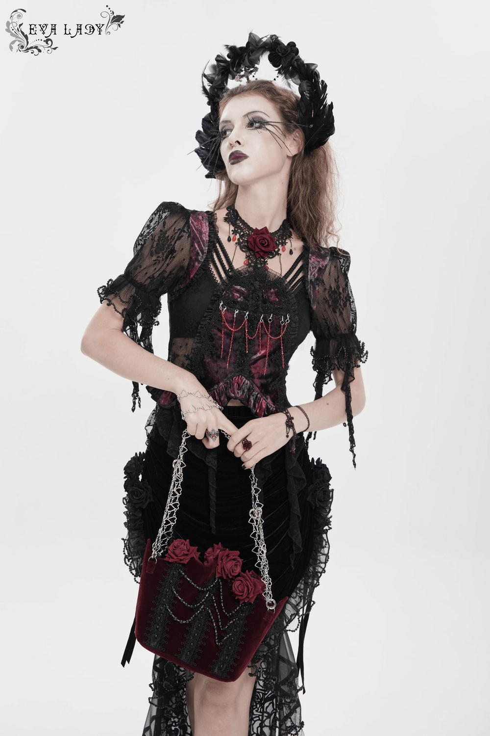 Alt Tag: Burgundy Gothic Rose Handbag with Lace and Chains held by model in black lace dress, velvet roses, bead drapes, silver heart chain straps