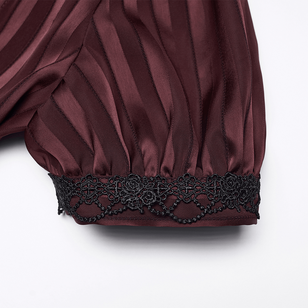 Detail of Burgundy Gothic Striped Lace-Up Puff Sleeve Shirt's black lace trim on puff sleeve, highlighting elegant design.