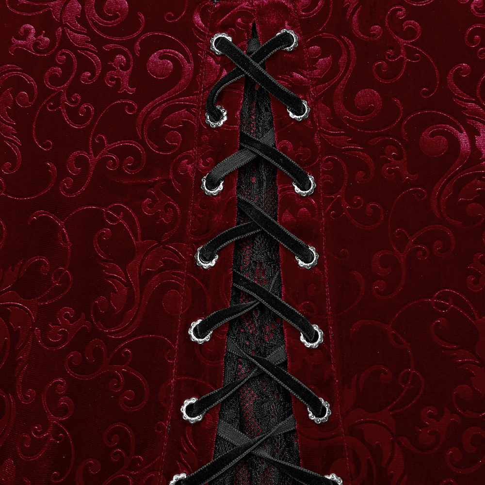 Close-up of burgundy velvet fabric with intricate embossed patterns and stylish black lace-up details.