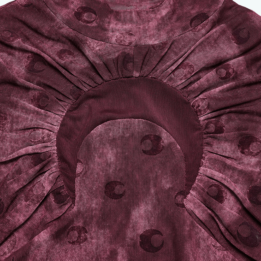 Close-up of burgundy mesh top showcasing crescent print and textured fabric details.