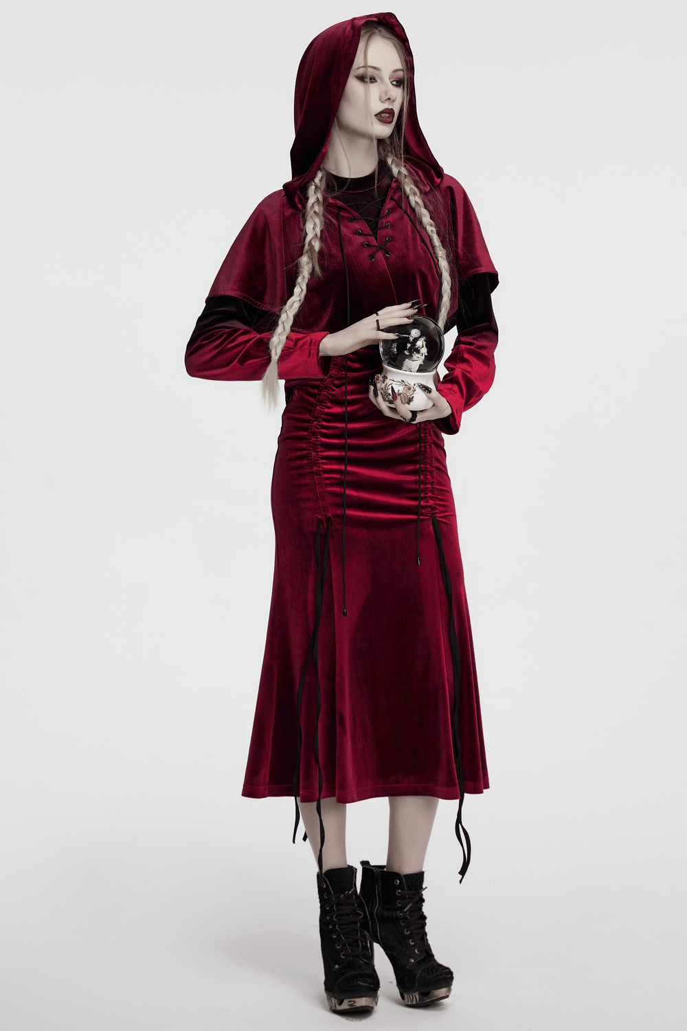 Burgundy velvet hooded cape with pom pom ties and lace-up detail, perfect for gothic or fantasy outfits.