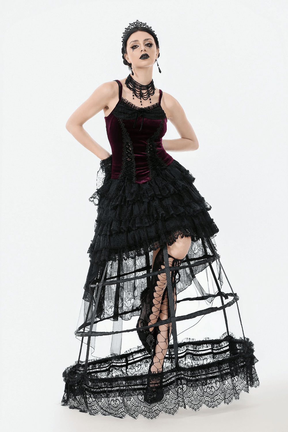 Burgundy velvet lace corset top with garter straps paired with a dramatic black ruffled skirt for a gothic look.