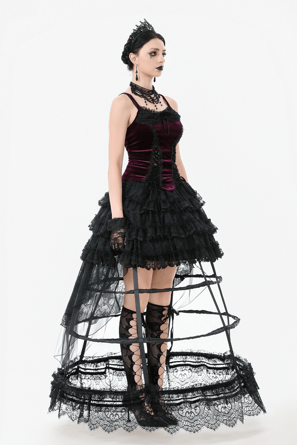 Burgundy velvet lace corset top with garter straps, layered black skirt, details of elegance and gothic flair.