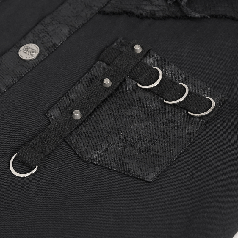 Close-up of black button front sleeveless shirt with metal embellishments and unique patched pocket.