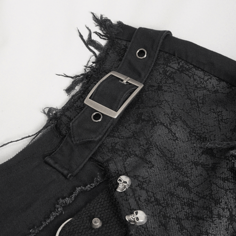 Close-up of edgy black sleeveless shirt featuring skull embellishments and a bold buckle design.