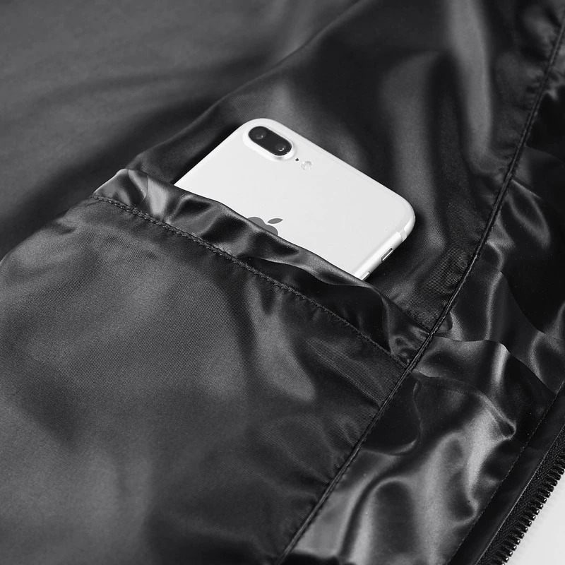 Close-up of a smartphone in the pocket of a stylish camouflage PU leather jacket.